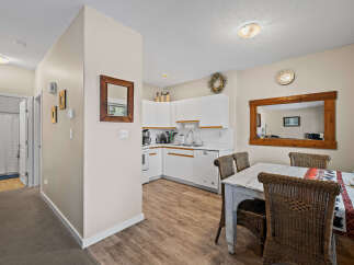 Step into this inviting space, featuring a well-lit kitchen with modern appliances and ample counter space.