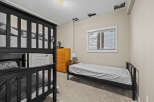This cozy bedroom features a bunk bed, perfect for accommodating guests or family members.