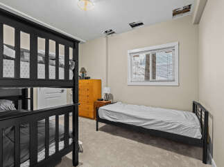 This cozy bedroom features a bunk bed, perfect for accommodating guests or family members.