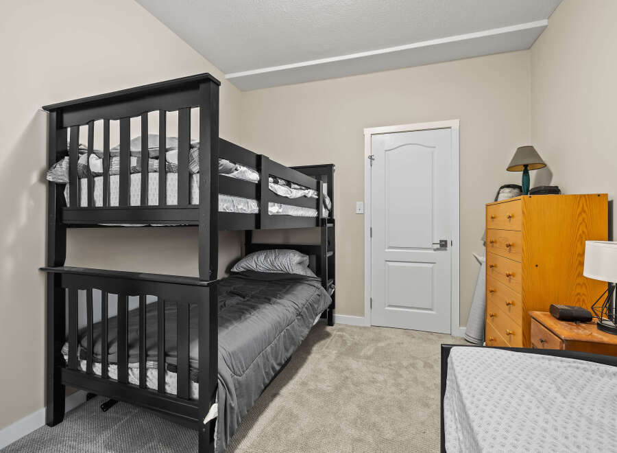 This cozy bedroom features a stylish bunk bed, perfect for kids or guests.