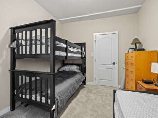 This cozy bedroom features a stylish bunk bed, perfect for kids or guests.