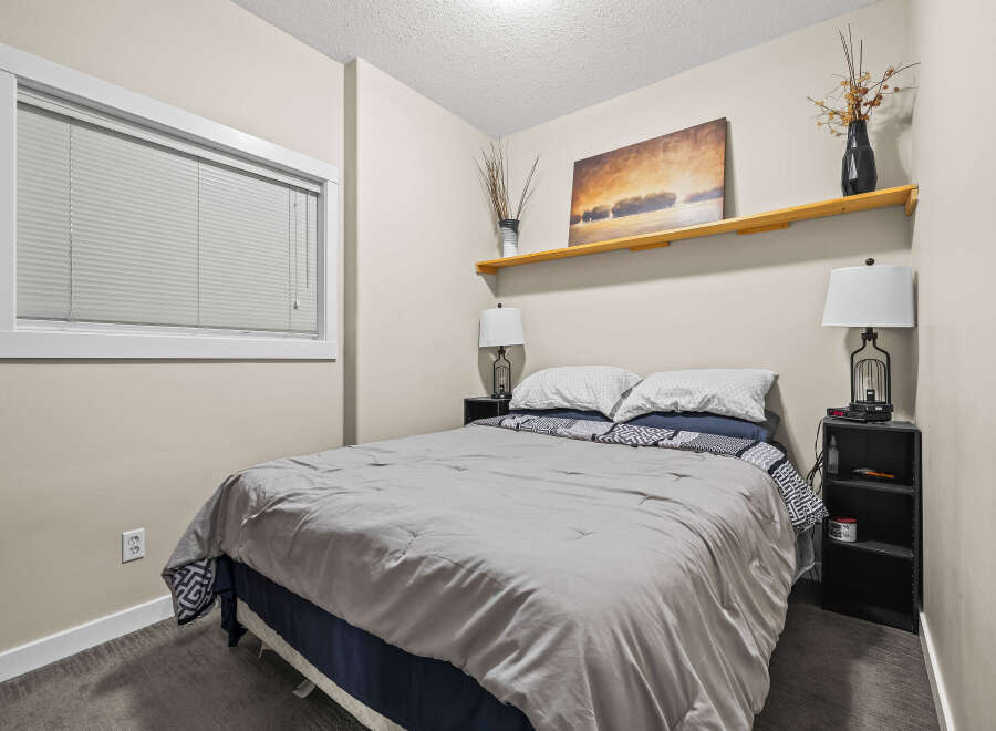 This cozy bedroom offers a serene retreat with its neutral color palette and inviting ambiance.