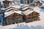 Experience luxury living in this stunning chalet nestled in a snowy mountain landscape.
