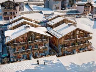 Experience luxury living in this stunning chalet nestled in a snowy mountain landscape.