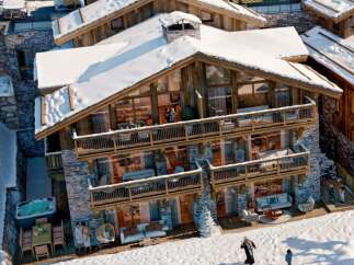 Experience luxury living in this stunning chalet nestled in a snowy landscape.