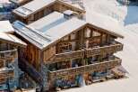 Experience luxury living in this stunning chalet nestled in a snowy landscape.
