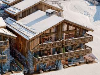 Experience luxury living in this stunning chalet nestled in a snowy landscape.