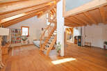 This stunning property boasts a warm and inviting interior with exposed wooden beams and a spacious layout.