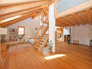 This stunning property boasts a warm and inviting interior with exposed wooden beams and a spacious layout.