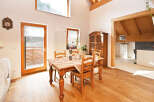 This charming dining room boasts a warm and inviting atmosphere, perfect for family gatherings and entertaining.