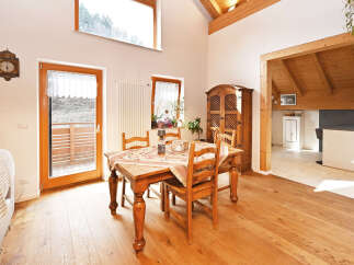 This charming dining room boasts a warm and inviting atmosphere, perfect for family gatherings and entertaining.