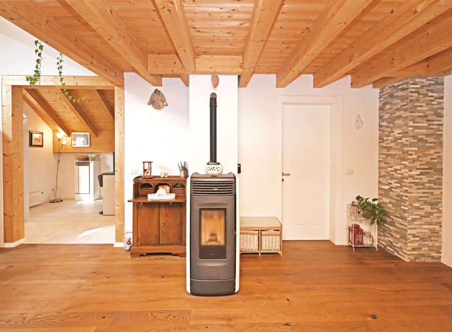 This stunning property boasts a warm and inviting interior with beautiful wooden floors and a unique wooden beam ceiling.