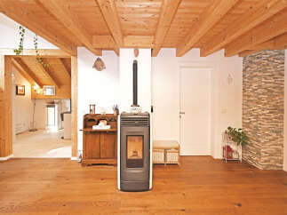 This stunning property boasts a warm and inviting interior with beautiful wooden floors and a unique wooden beam ceiling.