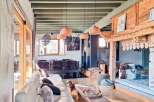 Discover the charm of this stunning property, featuring a spacious living area with a cozy fireplace and exposed wooden beams.