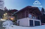 Discover a stunning chalet nestled in a snowy landscape, perfect for a luxurious mountain retreat.