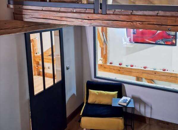 Discover this charming property featuring a unique loft design with exposed wooden beams, creating a warm and inviting atmosphere.