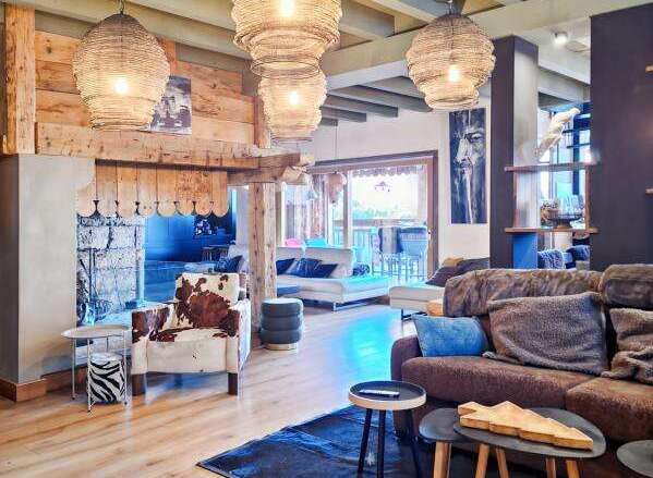 Experience luxury living in this stunning property, featuring a cozy living room with a fireplace and stylish decor.