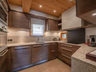 This stunning kitchen boasts custom cabinetry and granite countertops, creating a luxurious and functional space.
