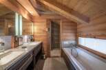 Experience luxury in this stunning bathroom featuring a sleek double vanity with granite countertops and ample storage.