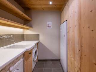 This laundry room features a modern design with wooden accents and a practical layout.