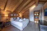 Experience the warmth and charm of this stunning bedroom, featuring exquisite wooden accents and a cozy ambiance.