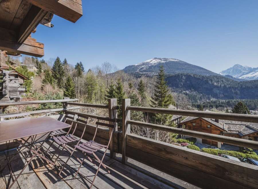 Enjoy breathtaking mountain views from this charming chalet balcony.