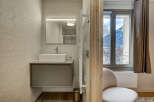 This modern bathroom boasts a sleek design with a floating vanity and a stylish rectangular sink.