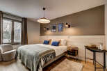This cozy bedroom features a comfortable bed with plush pillows and a stylish throw blanket.
