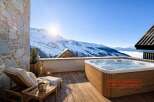 Enjoy breathtaking mountain views from this luxurious property featuring a private hot tub.