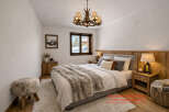 Experience the cozy charm of this bedroom, featuring a plush rug and a comfortable bed.