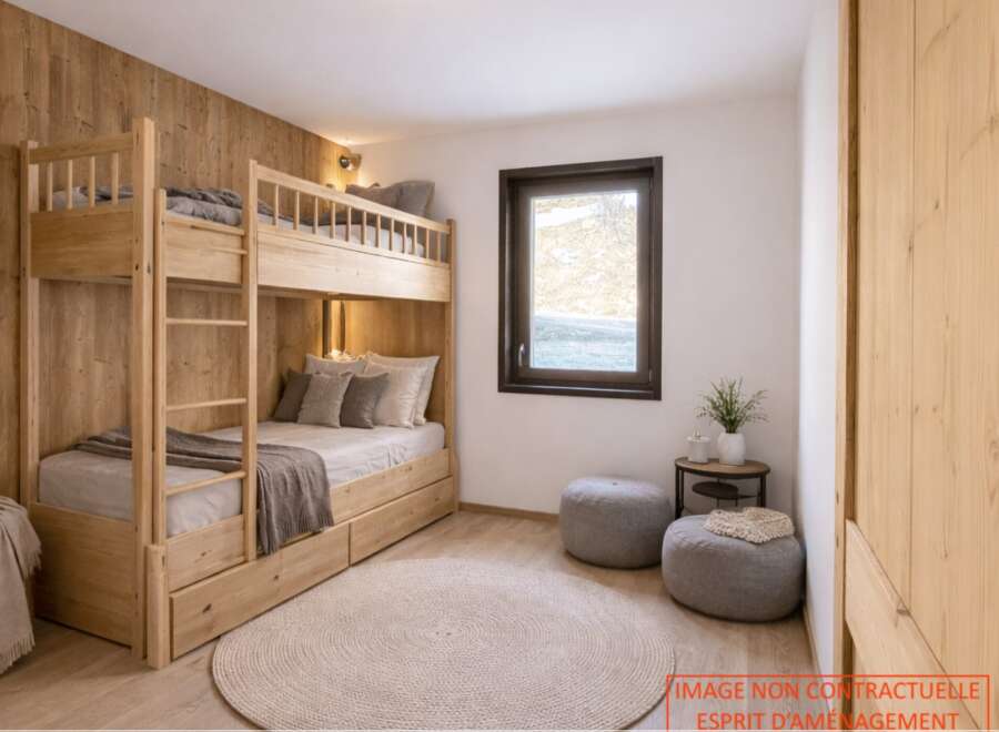 This cozy bedroom features a custom-built wooden bunk bed, perfect for maximizing space.