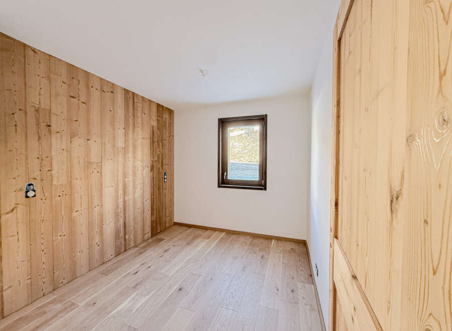 This stunning room features beautiful wooden paneling and flooring, creating a warm and inviting atmosphere.