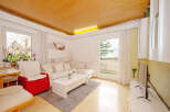 This bright and inviting living room offers a comfortable space for relaxation and entertainment.