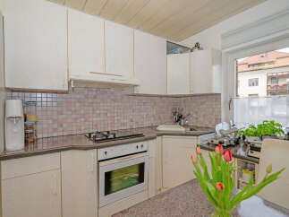 This charming kitchen offers a cozy and functional space, perfect for culinary enthusiasts.