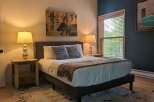 This inviting bedroom features a comfortable bed, perfect for relaxation.