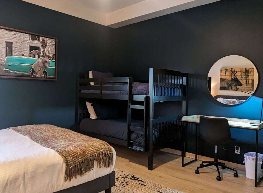 This stylish bedroom features a bunk bed, perfect for accommodating guests or family.