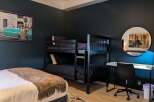 This stylish bedroom features a bunk bed, perfect for accommodating guests or family.