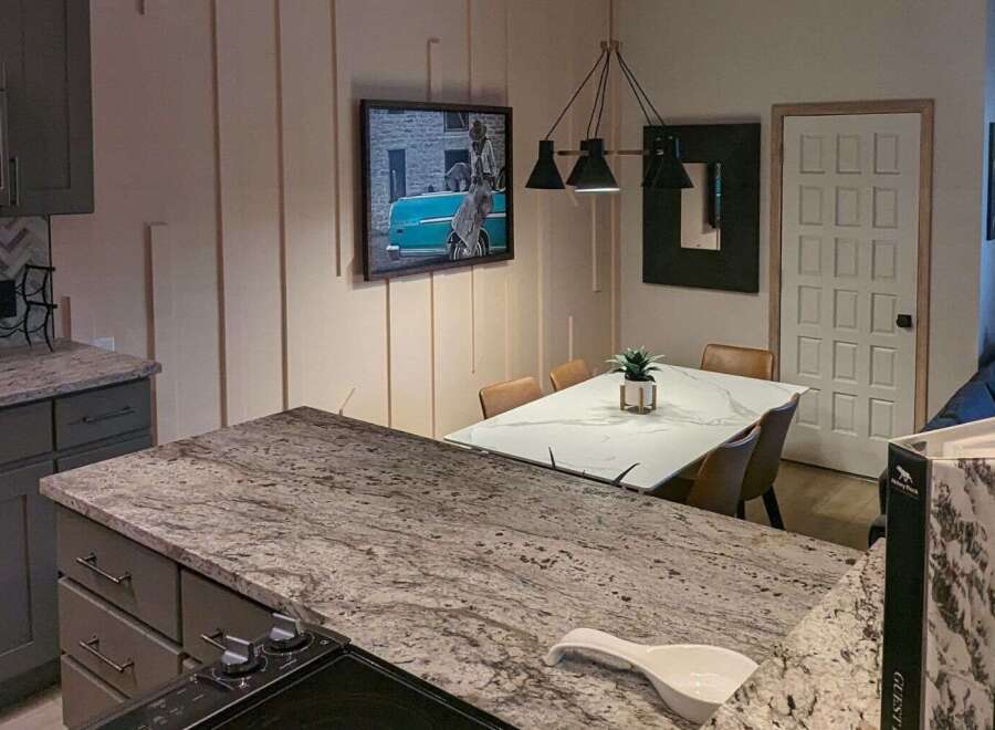 This stunning kitchen boasts a modern design with granite countertops and sleek cabinetry.
