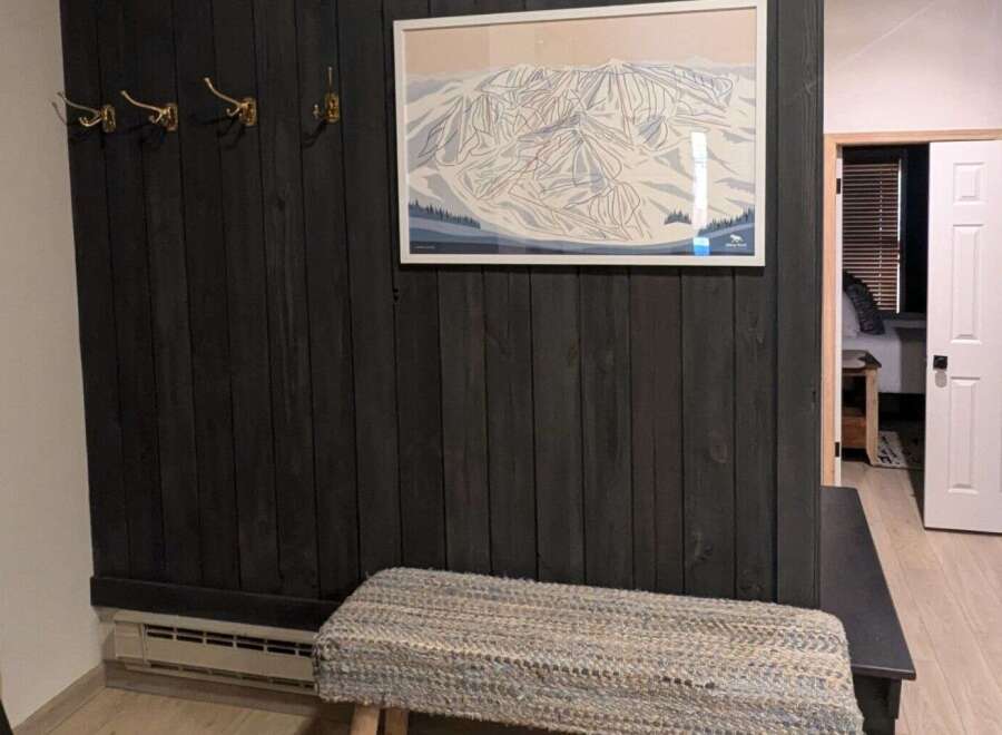 This stunning property features a beautifully designed entryway with a unique dark wood accent wall.