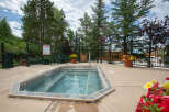 Enjoy a relaxing soak in this inviting hot tub, perfect for unwinding after a long day.