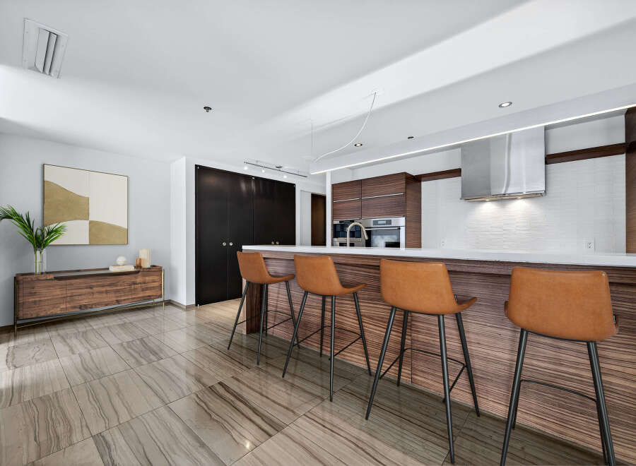 This stunning kitchen boasts a modern design with sleek cabinetry and a spacious island.
