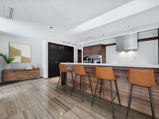 This stunning kitchen boasts a modern design with sleek cabinetry and a spacious island.