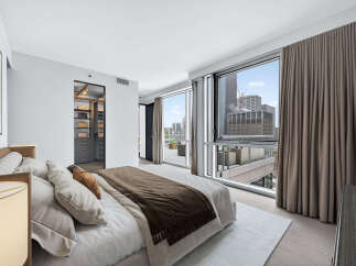Experience luxury living in this stunning bedroom with breathtaking city views.
