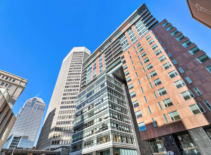 Explore the architectural marvel of this modern building, showcasing a blend of glass and brick facades.