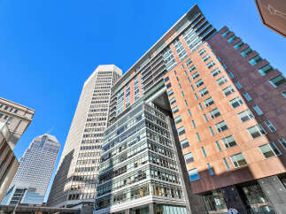 Explore the architectural marvel of this modern building, showcasing a blend of glass and brick facades.