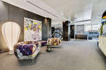 Step into luxury with this stunning property, featuring a modern lobby with stylish seating and unique artwork.