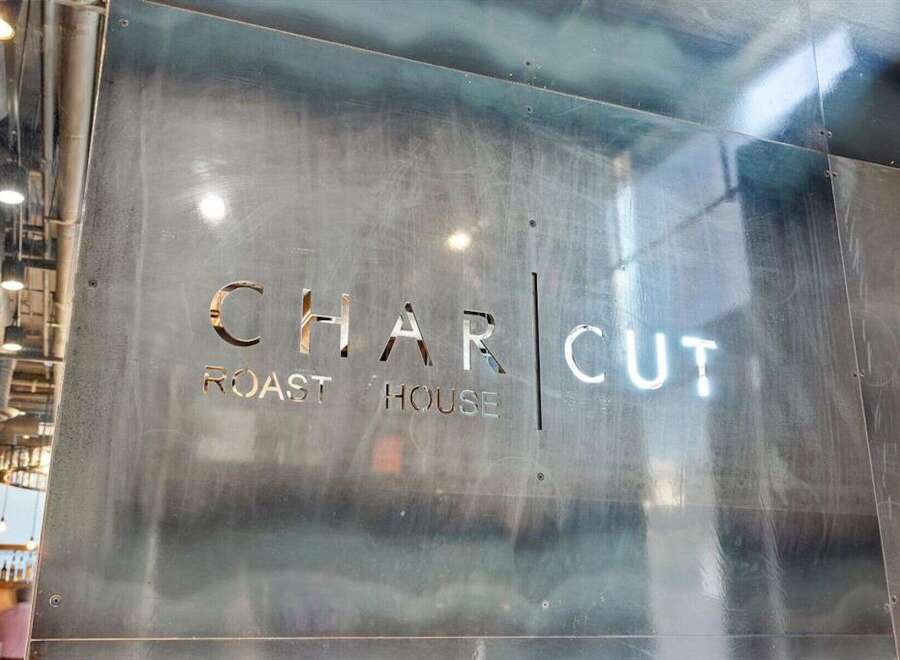 Discover the charm of this unique property, featuring a stylish 'CHAR CUT ROAST HOUSE' sign.