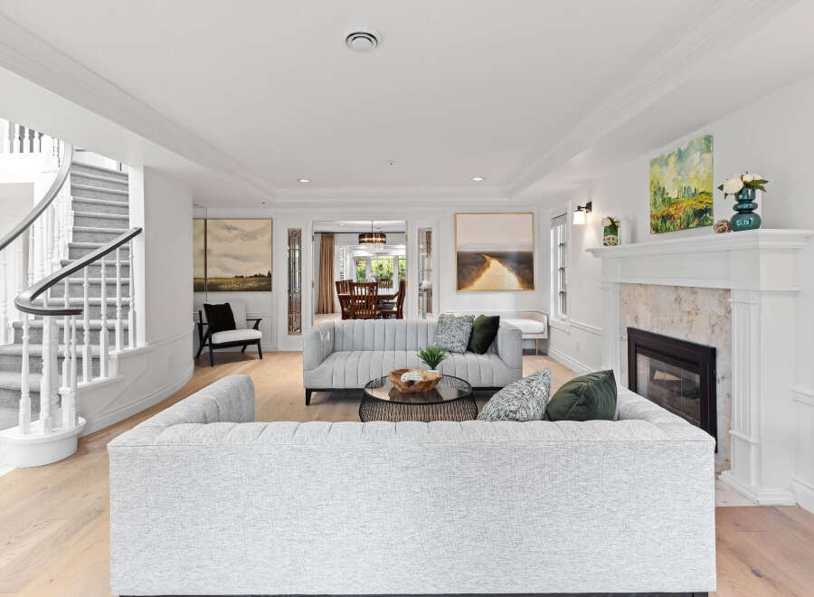 Step into luxury with this stunning property, featuring a spacious living room with a cozy fireplace and elegant design.