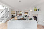 Step into luxury with this stunning property, featuring a spacious living room with a cozy fireplace and elegant design.