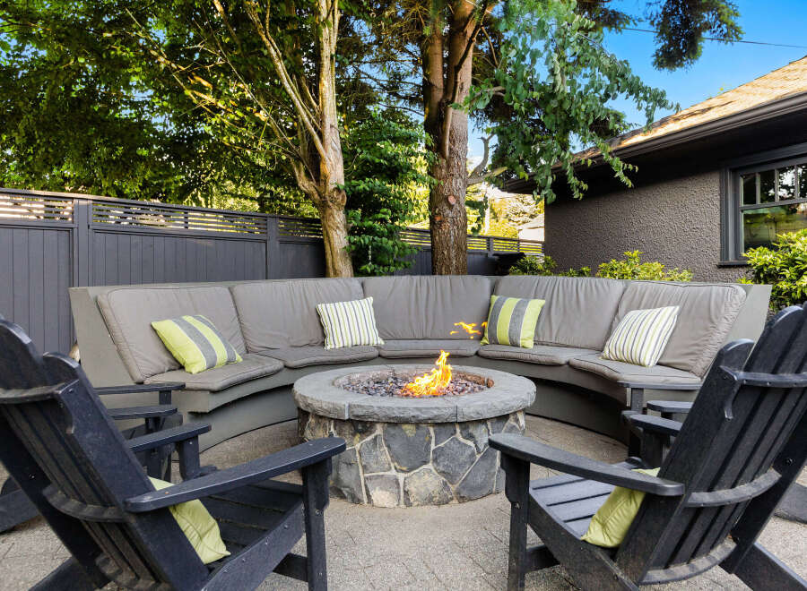 Enjoy outdoor living at its finest with this stunning property! Featuring a cozy fire pit surrounded by comfortable seating, perfect for entertaining or relaxing.